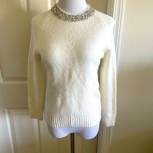 Crew neck fitted sweater with jeweled neck design